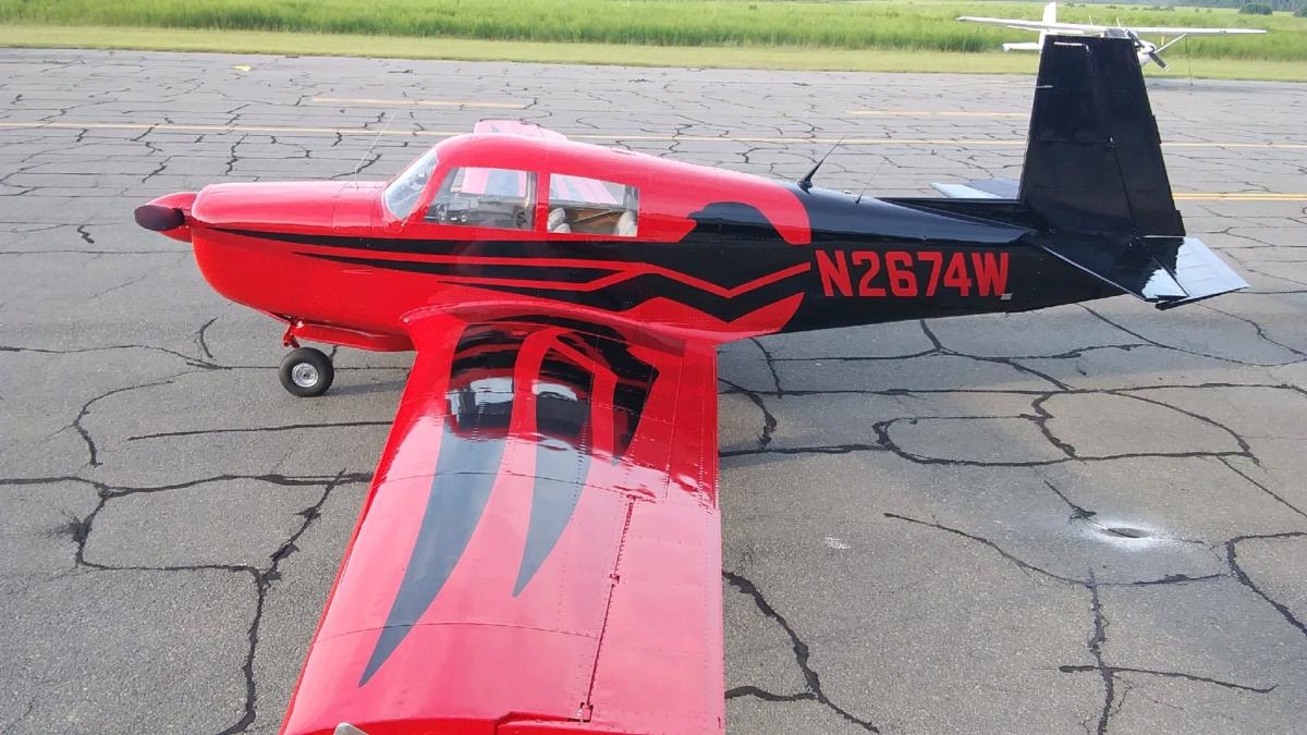 Mooney painted bright red with a gloss-black spine and accents